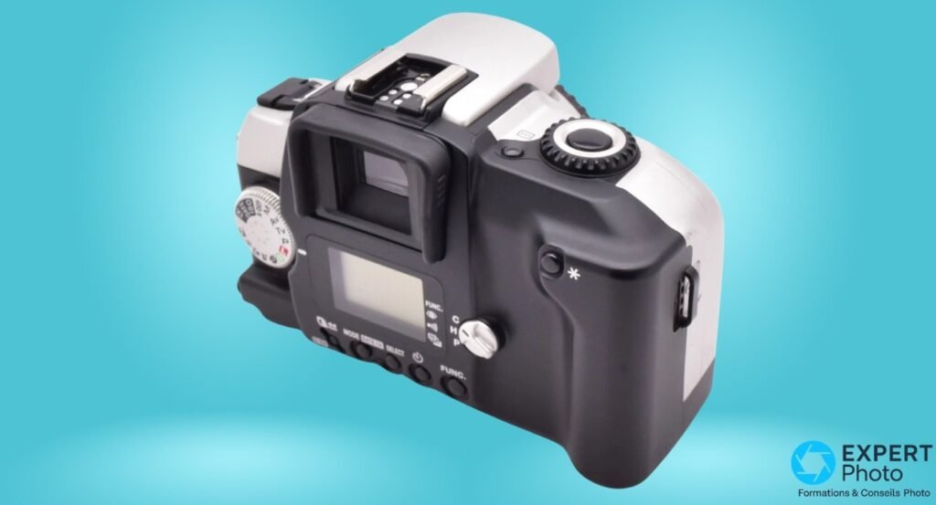 Canon EOS IX Lite argentique, dos 3/4, viseur oculaire reflex, écran LCD, sélecteur APS C/H/P, boutons MODE FUNC