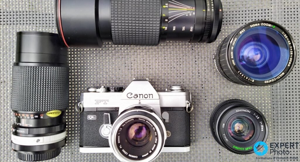 Canon FT QL entouré de quatre objectifs à monture FL : téléobjectifs noirs, Sigma Zoom 35-80mm et Chinon 28mm f/2.8.