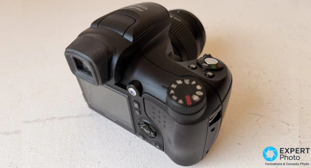 Dos du Fujifilm FinePix S6500fd avec viseur électronique, écran LCD 2,5 pouces, molette de mode et grip texturé