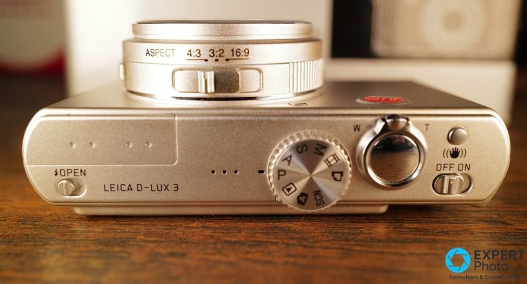 Leica D-Lux 3 vue du dessus, bague sélecteur de format 4:3 3:2 16:9 autour de l'objectif, molette de mode.