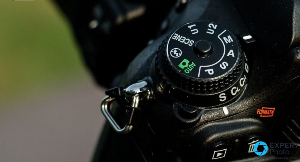 Gros plan molette de modes Nikon D600 : positions P, S, A, M, U1, U2, SCENE et AUTO (vert) lisibles en détail.