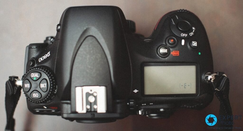 Vue de dessus du Nikon D800 montrant les molettes QUAL, WB, ISO, BKT, griffe flash centrale et écran LCD d'état