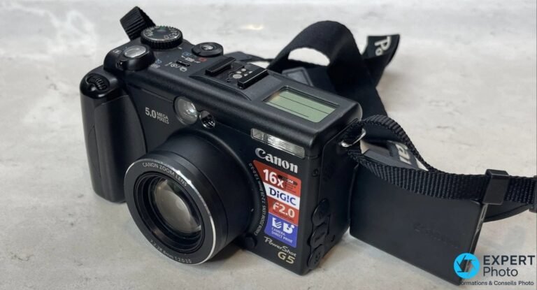 Canon PowerShot G5 noir vu en trois-quarts avant face, objectif rétracté, marquages 5.0 Mégapixels et zoom 4× lisibles.