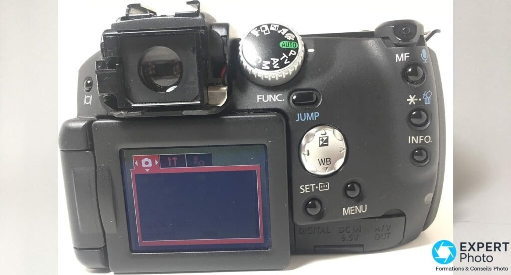 Canon PowerShot Pro1 vu de dos, écran LCD orientable allumé sur le menu Canon classique de 2004 avec onglets et réglages. 
