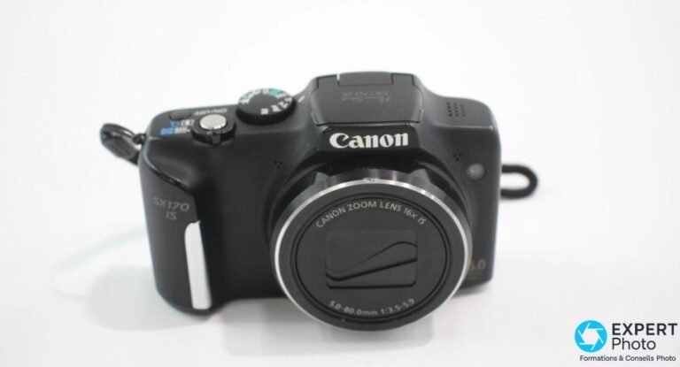 Canon PowerShot SX170 IS vue de face trois-quarts, logo Canon et objectif 16× IS 5.0-80mm f/3.5-5.9 visibles.