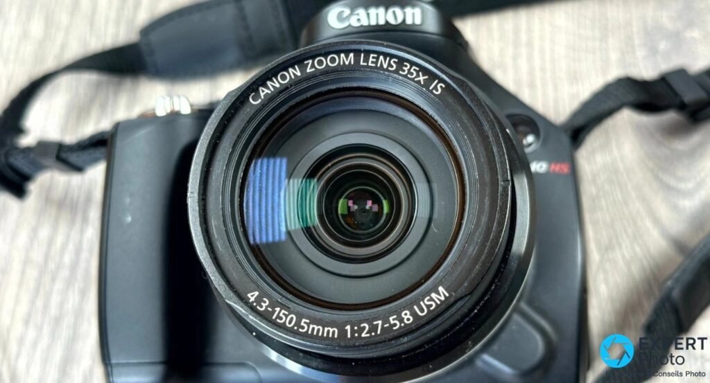 Gros plan frontal de l'objectif Canon Zoom Lens 35x IS du SX40 HS, marquage 4.3-150.5mm 1:2.7-5.8 USM lisible. 