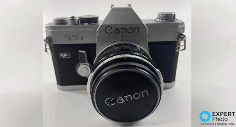 Canon TL QL 1968 vue de face avec bouchon Canon, marquages TL et QL visibles, prisme et objectif Canon FL.