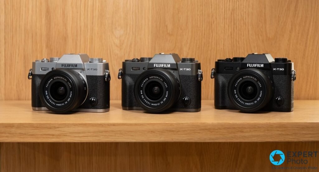 Trois Fujifilm X-T30 III alignés sur étagère bois en finitions argent, anthracite et noire avec kit XC 13-33 mm monté.