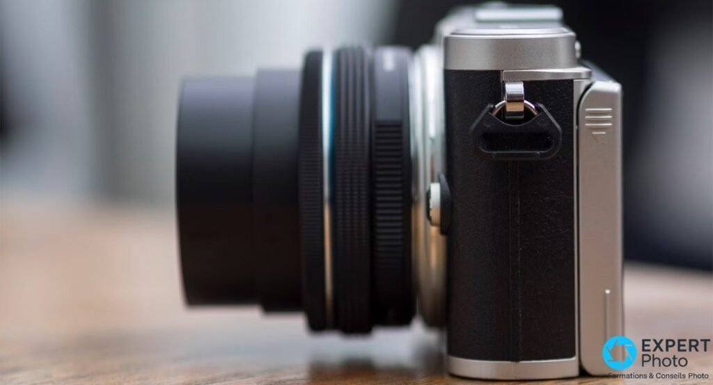 Olympus PEN E-PL9 vu de profil, revêtement cuir noir et capot argenté, objectif zoom 14-42mm déployé.