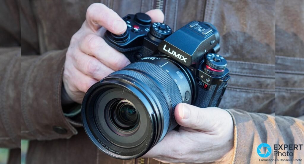 Panasonic Lumix S1 II tenu à deux mains, objectif Lumix S 1:2.8/24-60mm ø77 monté, vue 3/4 avant extérieur