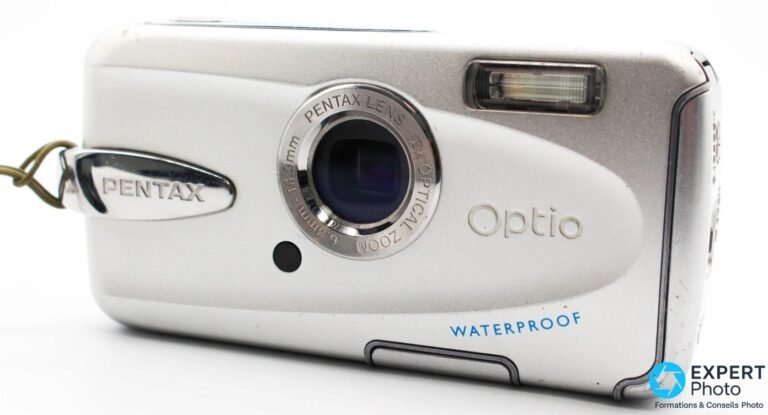 Pentax Optio W30 argenté, face avant 3/4 gauche, marquage WATERPROOF et logo Optio visibles, objectif rétracté