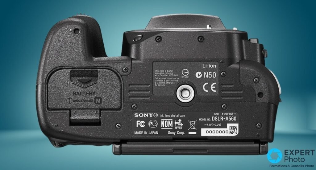 Semelle du Sony Alpha 560 avec étiquette « MODEL NO. DSLR-A560 », MADE IN JAPAN, trappe batterie et filet de trépied. 