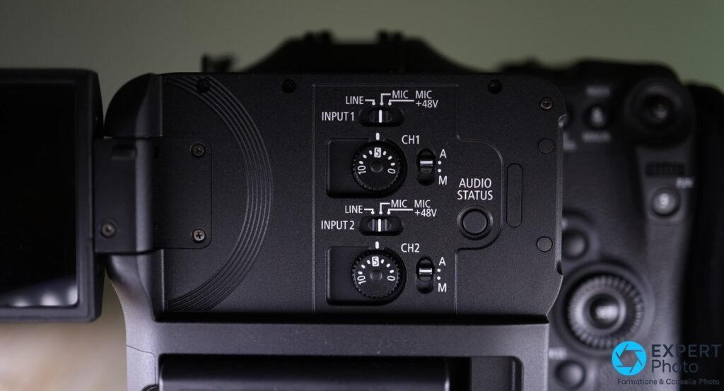 Détail panneau audio Canon EOS C70 : sélecteurs INPUT 1 et INPUT 2, molettes de gain CH1 et CH2, modes Line/MIC/MIC +48V