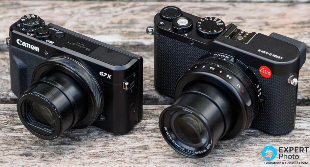 Canon PowerShot G7X Mark II à gauche et Leica D-Lux 8 à droite, vue 3/4 avant côte à côte, bois gris