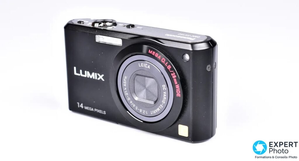 Panasonic Lumix DMC-FX150 noir, 3/4 avant droit, objectif Leica Vario-Elmarit rétracté, bague MEGA O.I.S. rouge, fond blanc 