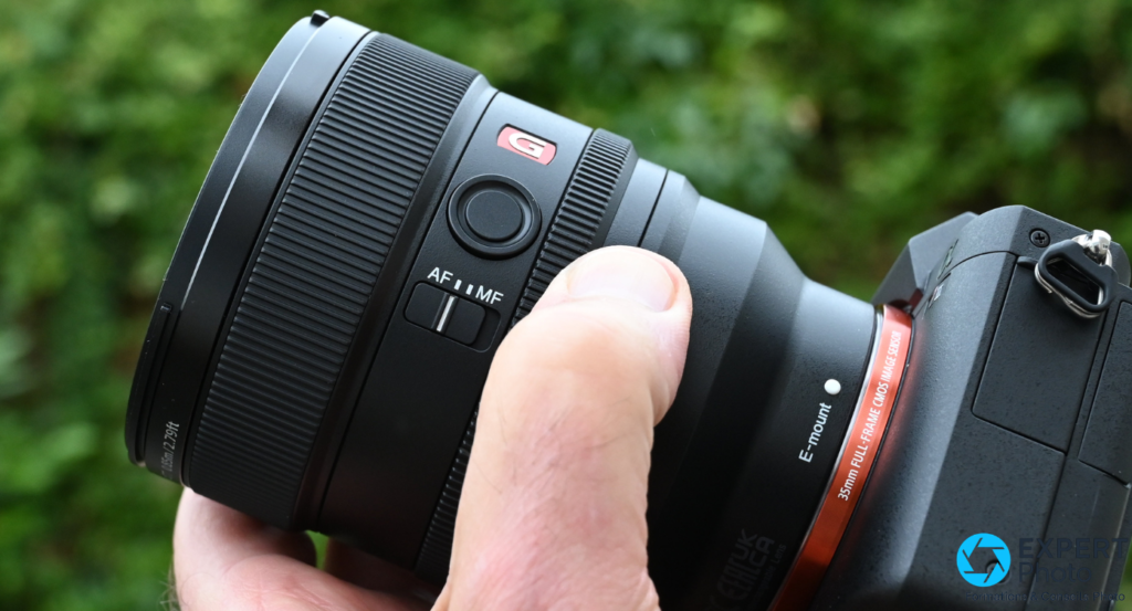 Sony FE 85mm f/1.4 GM II, commutateur AF/MF et bouton de mise au point, logo G rouge, bague E-mount boîtier Sony visible.