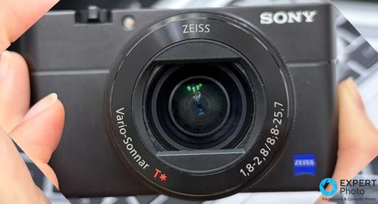Sony RX100 VA face avant, objectif Zeiss Vario-Sonnar T* 1,8-2,8 sorti, lentilles frontales visibles, logos SONY et ZEISS lisibles
